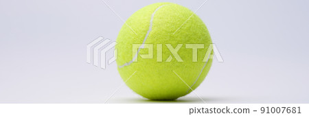Bright lime tennis ball on white background closeup Bright lime tennis ball on white background closeup 91007681