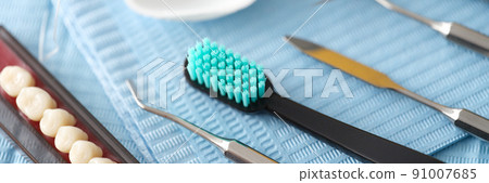 Dental instrument dental floss and dental implants closeup 91007685