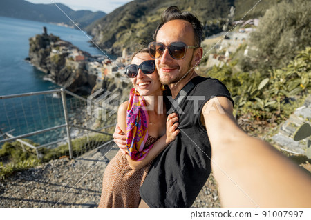 Selfie photo of couple on background of mediterranean coast in Italy Selfie photo of couple on background of mediterranean coast in Italy 91007997