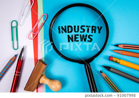 Industry News. Text and office supplies on a blue background Industry News. Text and office supplies on a blue background 91007998