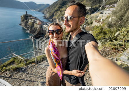 Selfie photo of couple on background of mediterranean coast in Italy 91007999