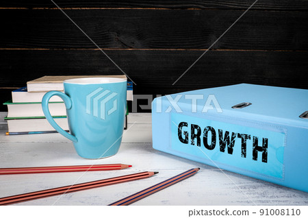Growth. Blue document binder on office desk 91008110