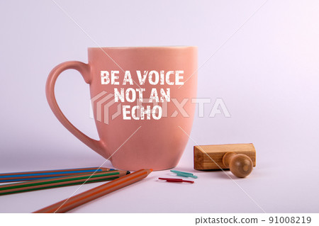 BE A VOICE NOT AN ECHO. Mug and office supplies on a white background 91008219
