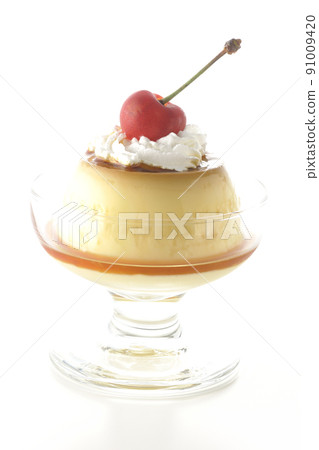 A traditional retro pudding with cherries and cream on a sundae cup taken on a white background 91009420