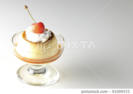 A traditional retro pudding with cherries and cream on a sundae cup taken on a white background 91009553