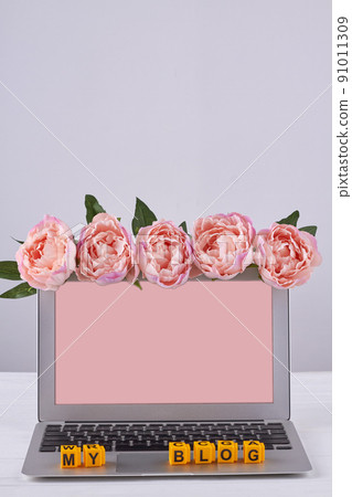Laptop view pink screen for copy space decorated with flowers. Laptop view pink screen for copy space decorated with flowers. 91011309