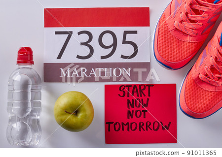 Flat lay red accessories for marathon on white background. Flat lay red accessories for marathon on white background. 91011365