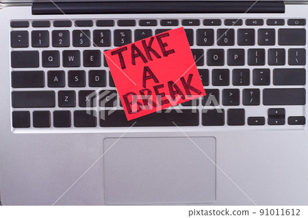 Paper with message take a break on keyboard. Paper with message take a break on keyboard. 91011612