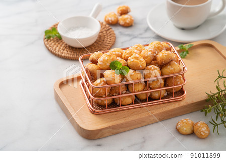 Delicious French Chouquette Choux Pastry dessert Pearl Sugar Puff on white marble background. 91011899
