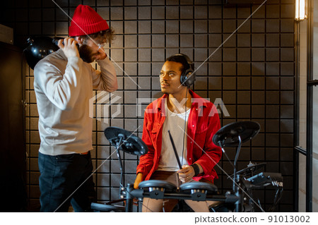 Men playing electric drums at home sstudio 91013002