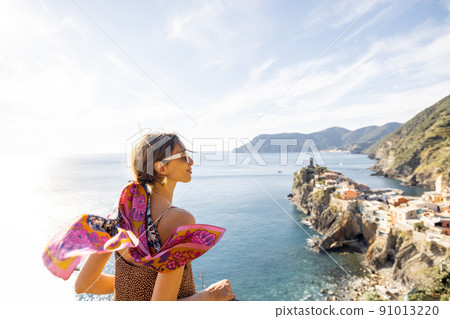 Woman traveling famous Cinque Terre towns in northwestern Italy 91013220