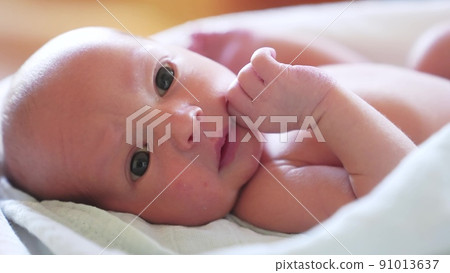 newborn. baby newborn a close-up lies looking lifestyle at the camera in the hospital maternity hospital. happy family baby dream concept. cute newborn baby wrapped in a blanket newborn. baby newborn a close-up lies looking lifestyle at the camera in the hospital maternity hospital. happy family baby dream concept. cute newborn baby wrapped in a blanket 91013637