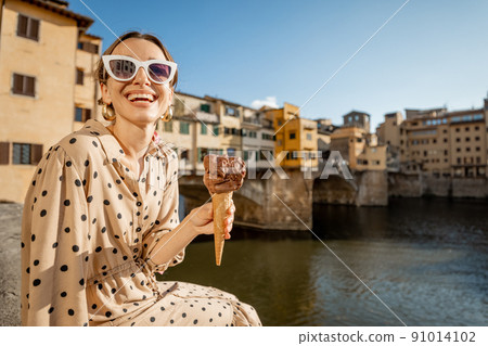 Woman with italian ice cream in Florence, Italy 91014102