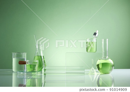 Front view of transparent podium with laboratory equipment and green leaf in green background science content 91014909