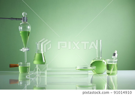 Front view of transparent podium with laboratory equipment and green leaf in green background science content 91014910