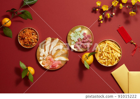 Tet holiday with mandarin orange candy jam , fried potato , flower and ang pao biscuit in golden dish , photography Tet holiday content Tet holiday with mandarin orange candy jam , fried potato , flower and ang pao biscuit in golden dish , photography Tet holiday content 91015222