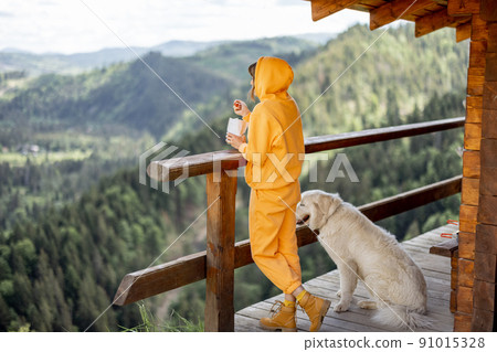 Woman enjoys great view on mountains during a lunchtime Woman enjoys great view on mountains during a lunchtime 91015328