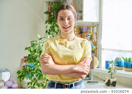 Portrait of smiling teenager girl 14, 15 years old looking at camera, at home in room Portrait of smiling teenager girl 14, 15 years old looking at camera, at home in room 91016074