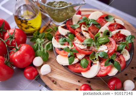 Caprese salad - sliced mozzarella cheese and tomatoes Caprese salad - sliced mozzarella cheese and tomatoes 91017148