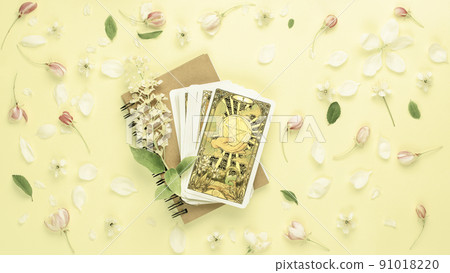 Blurred yellow flowers background with Tarot cards. Esoteric concept, fortune telling and predictions 91018220