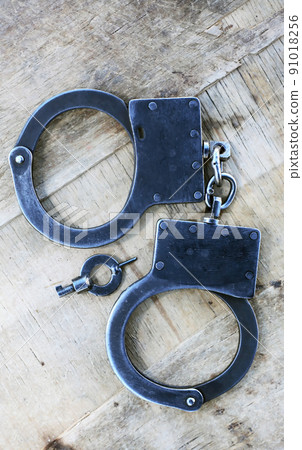 Handcuffs On Wood 91018256