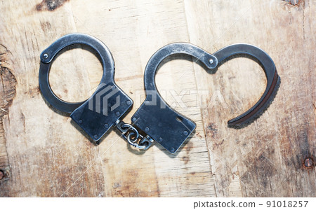 Handcuffs On Wood 91018257