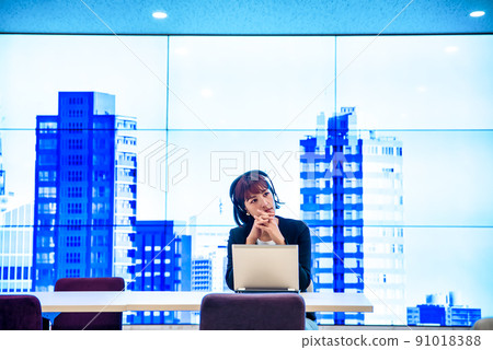 Free address Business person with a headset working in the office Free address Business person with a headset working in the office 91018388