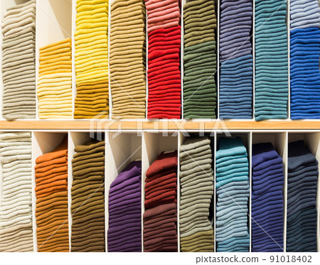 The colourful socks are arranged on the shelf for sale in a shopping mall. The colourful socks are arranged on the shelf for sale in a shopping mall. 91018402
