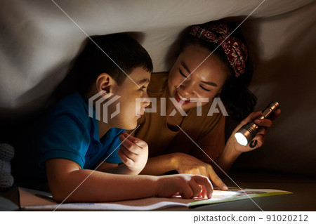 Mother and Son Reading under Blanket Mother and Son Reading under Blanket 91020212