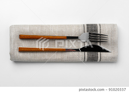 Set of fork and knife on towel. Isolated on white background. Set of fork and knife on towel. Isolated on white background. 91020337