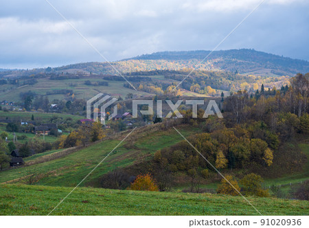 Cloudy and foggy autumn mountain countryside scene. Carpathians, Ukraine. Peaceful picturesque traveling, seasonal, nature and countryside beauty concept scene. 91020936