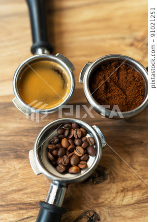 Different processes of preparing coffee by a barista in a coffee shop. Coffee beans, ground, ready. Coffee art concept. Top view, close-up. Different processes of preparing coffee by a barista in a coffee shop. Coffee beans, ground, ready. Coffee art concept. Top view, close-up. 91021251