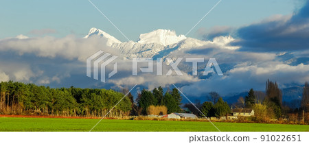 Pastoral overview over Fraser valley farm lands on snowy mountains background 91022651