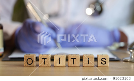 Otitis word made with wooden cubes in row Otitis word made with wooden cubes in row 91023103