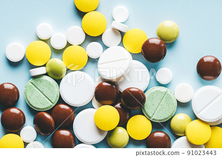 Close up of various pills on blue background. Close up of various pills on blue background. 91023443