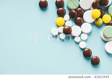 Various pills on blue background with copy space. 91023445