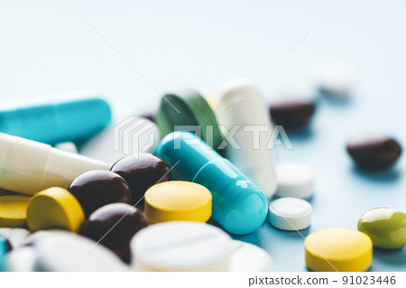 Various pills on blue background, angle view. 91023446
