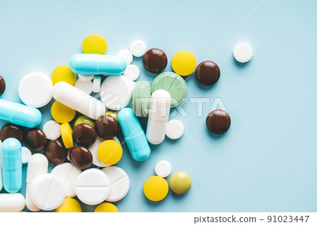 Various pills on blue background, top view. 91023447