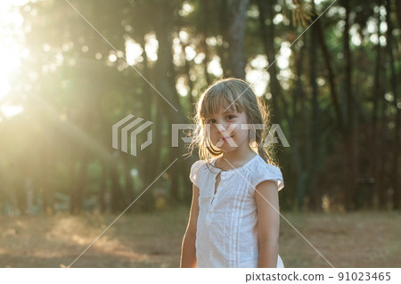 Adorable little child girl having fun on a sunny summer day outdoor in sunlight Adorable little child girl having fun on a sunny summer day outdoor in sunlight 91023465