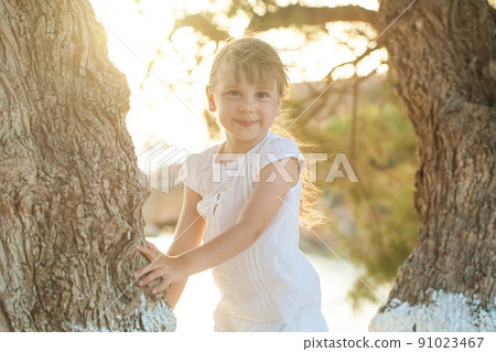 Portrait of a happy little child girl having fun outdoors Portrait of a happy little child girl having fun outdoors 91023467