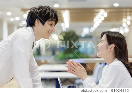 Men and women chatting in the office conversation Men and women chatting in the office conversation 91024323
