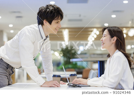 Men and women chatting in the office conversation Men and women chatting in the office conversation 91024346