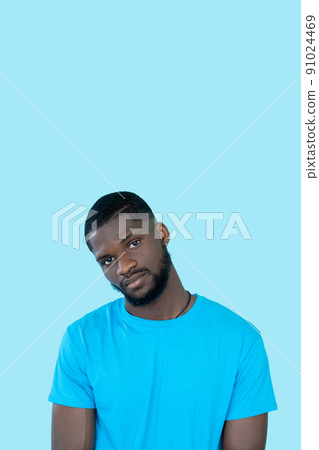 Serious guy. Studio portrait. Skeptic expression. Flyer design. Handsome young beardy careless man isolated on blue copy space background. Serious guy. Studio portrait. Skeptic expression. Flyer design. Handsome young beardy careless man isolated on blue copy space background. 91024469