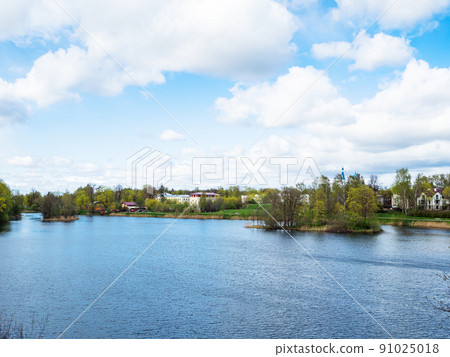 white clouds in blue sky over lake in Gatchina 91025018