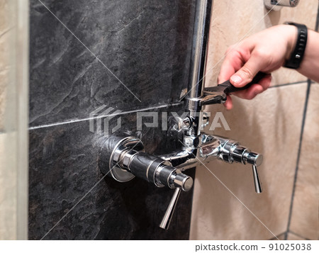 plumber installs shower pipe to faucet valve 91025038