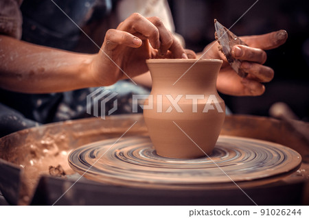 hands of potter do a clay pot 91026244