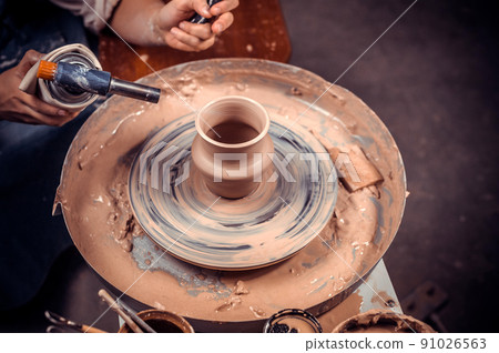 Master class on modeling of clay on a potter's wheel In the pottery workshop 91026563