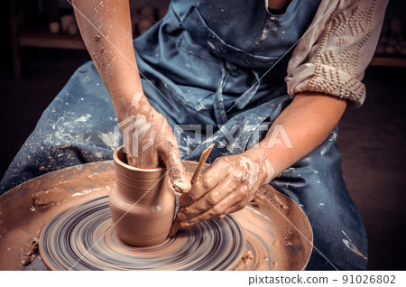 hands of potter do a clay pot 91026802