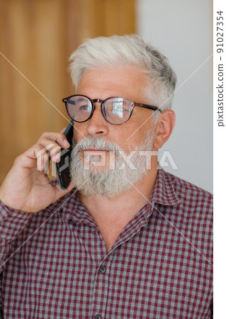 man talks on the phone with colleagues or business partners, solving financial and legal problems man talks on the phone with colleagues or business partners, solving financial and legal problems 91027354