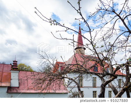 blossoming tree and Priory Palace in spring 91027880
